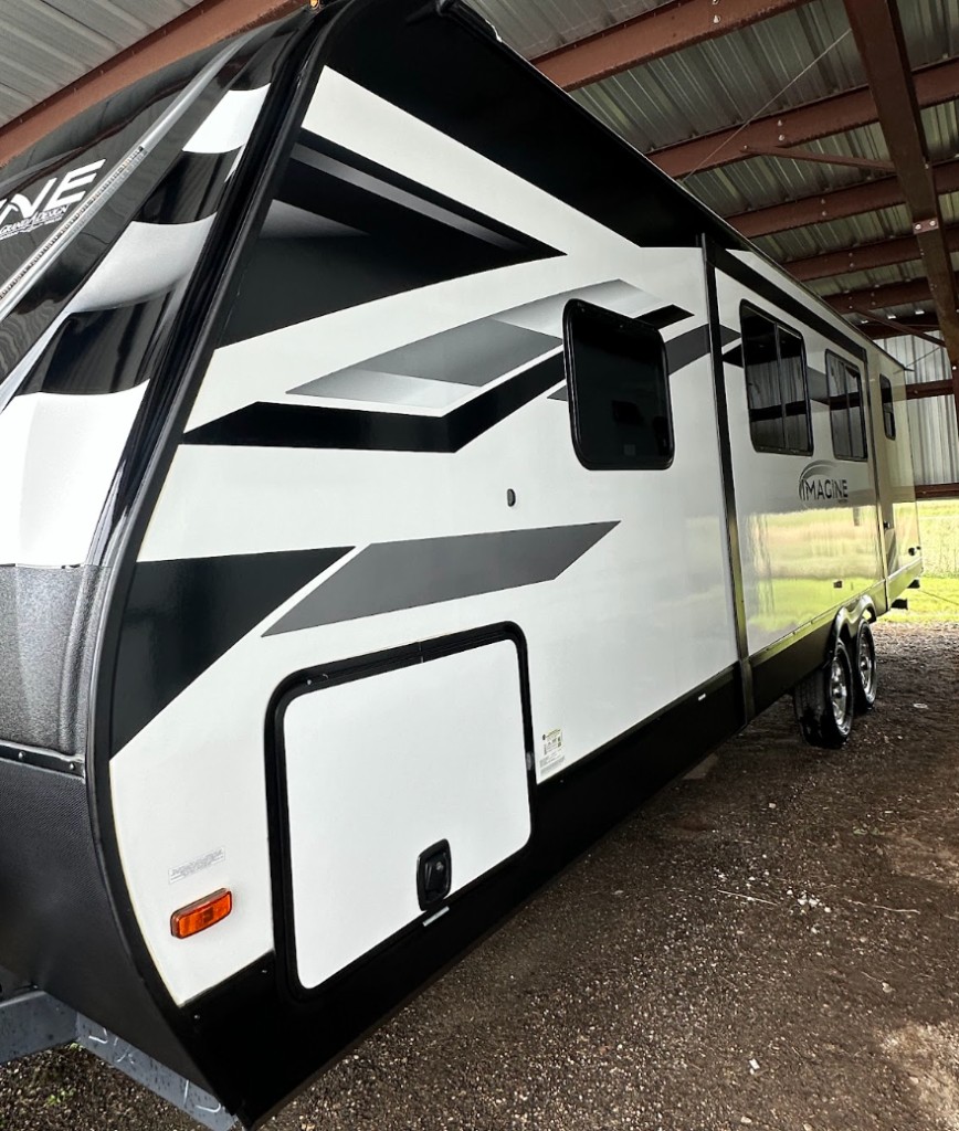 Glossy white travel trailer after professional RV detailing
